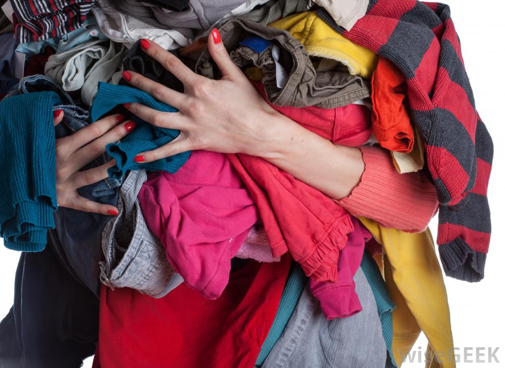 woman-holding-pile-of-clothes